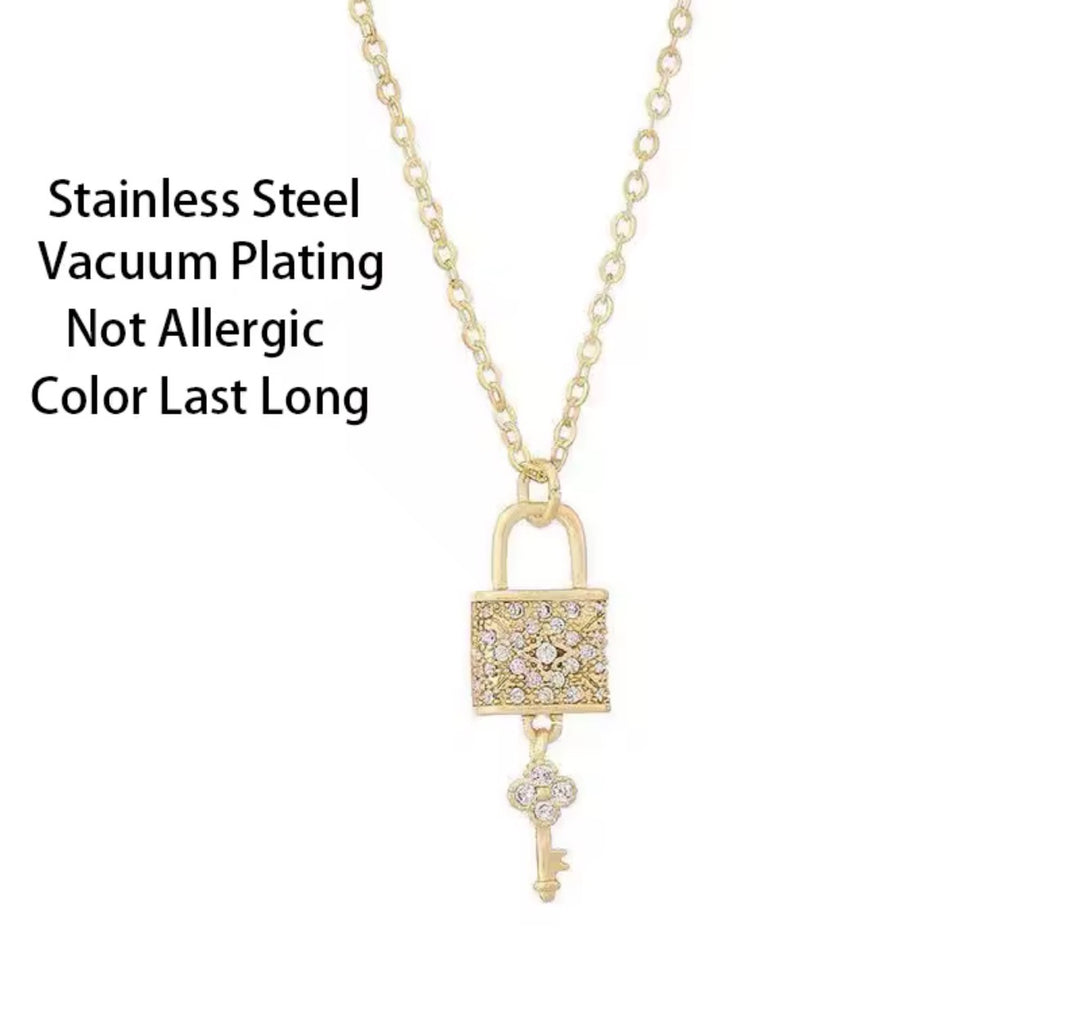 Gold lock and key pendant necklace with crystal detail on a fine gold chain