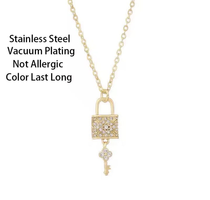 Gold lock and key pendant necklace with crystal detail on a fine gold chain