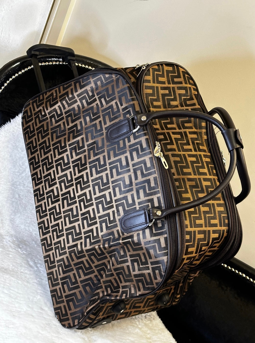 Black and brown geometric patterned holdall with wheels