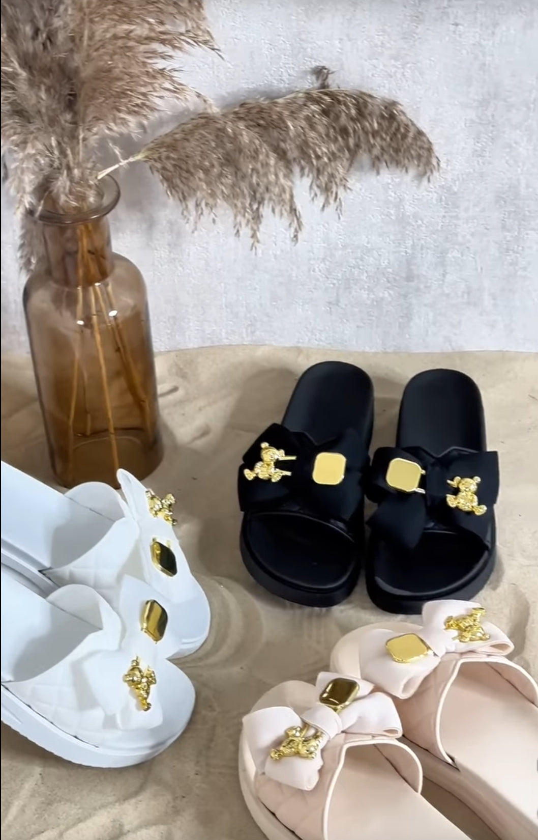 Black, beige and white sandals with decorative bows 