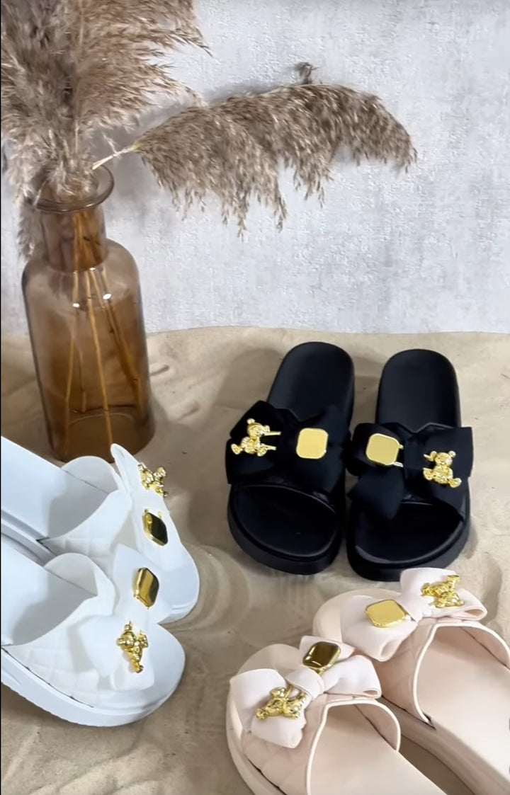 Black, beige and white sandals with decorative bows 