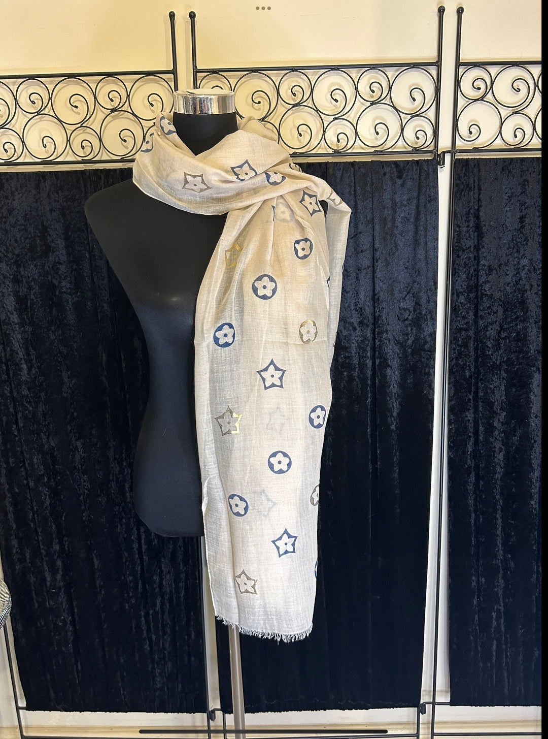 Thin lightweight scarf with flower print design, ideal for spring and summer wear.