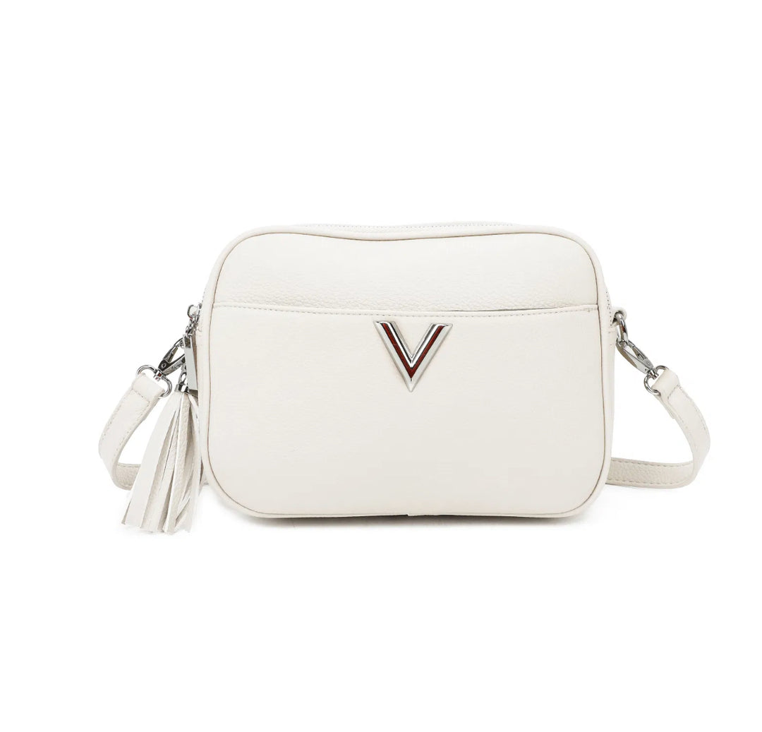 A white faux leather crossbody bag with a double zip closure, silver tone metal hardware, and an adjustable long strap. It features a front pocket,