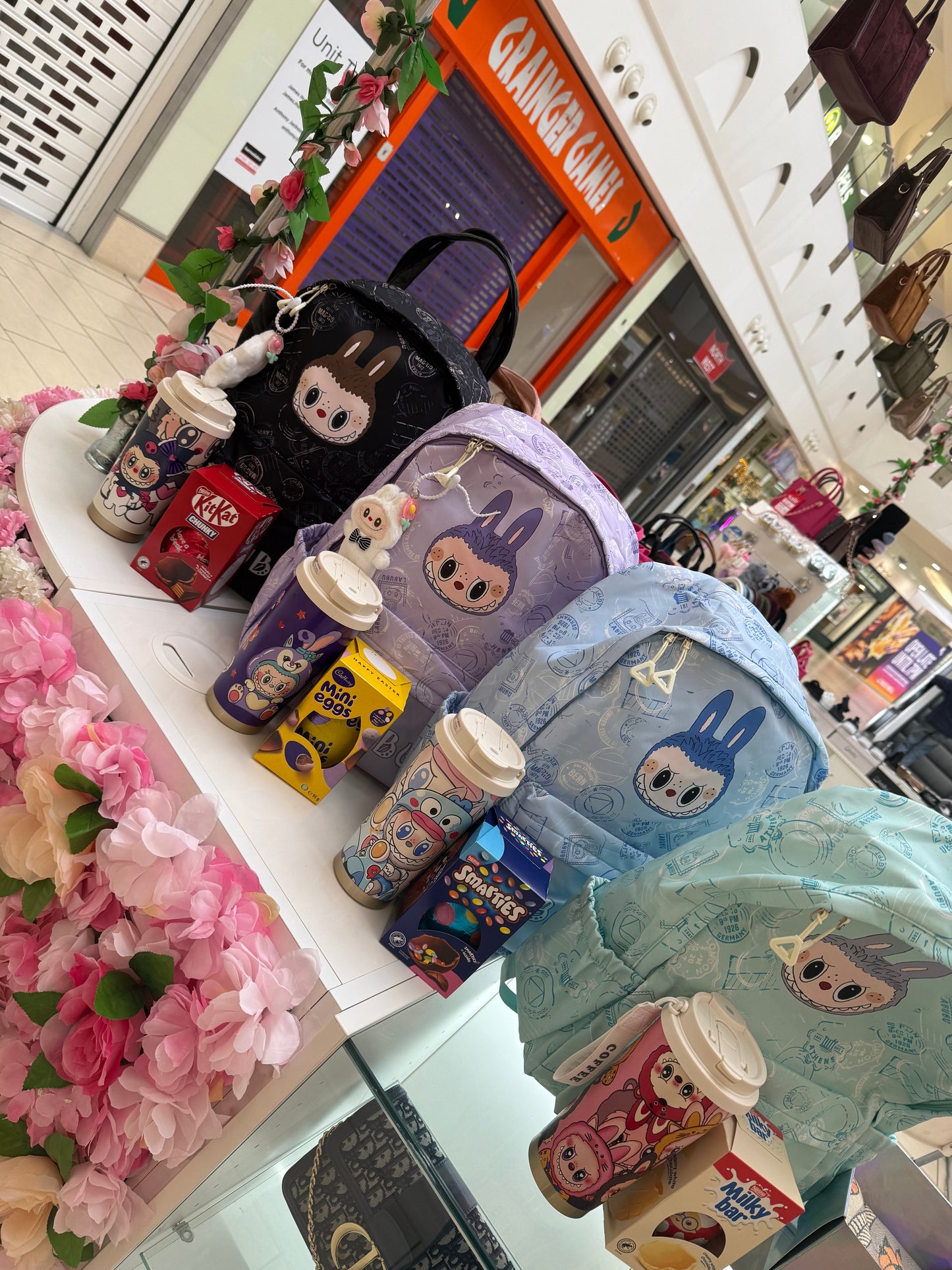 Colourful children’s backpacks with matching water bottle and Easter eggs 