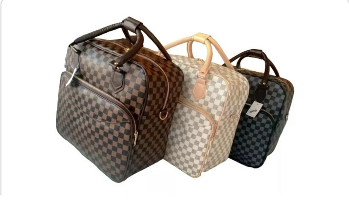 Three checkered bags/ luggage bag with different coloured handles 