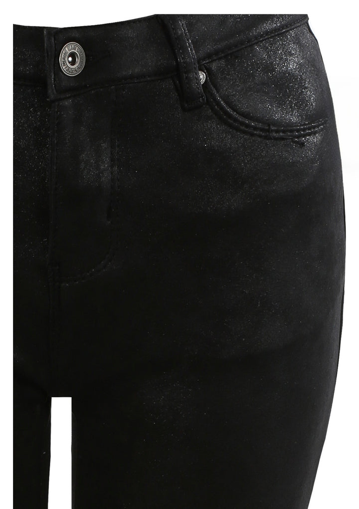 Close-up of black jeans with a button and zipper with shimmer detail