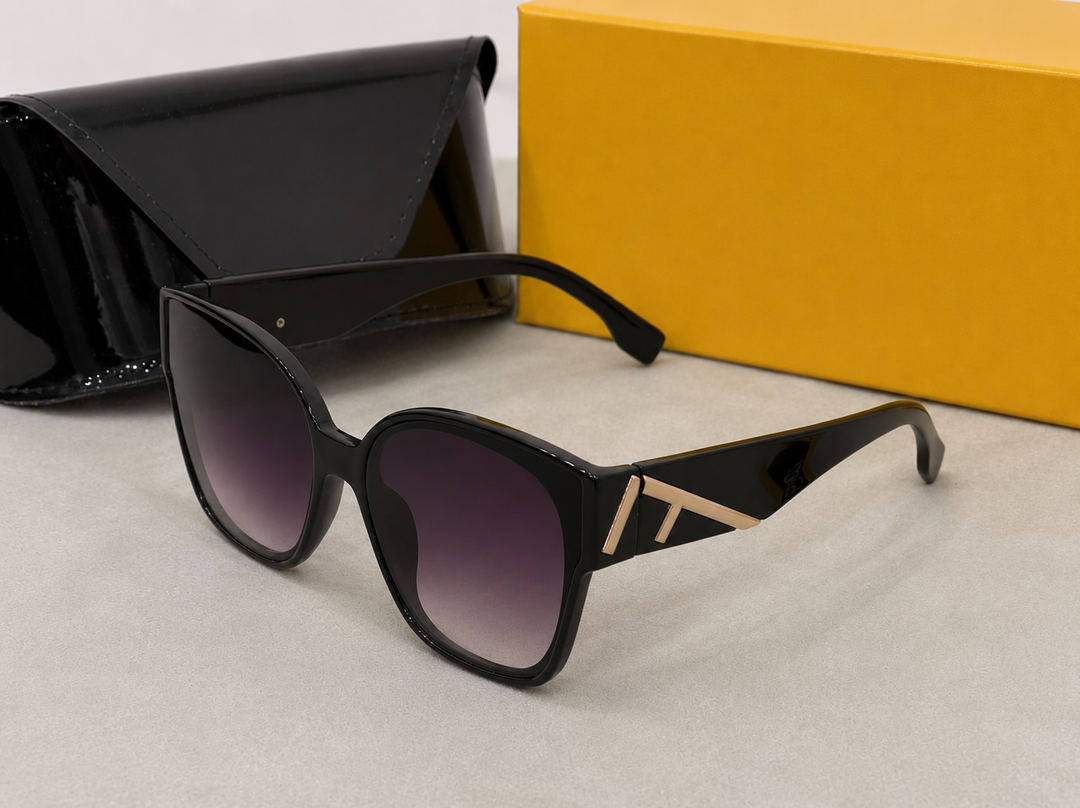Oversized black sunglasses with gradient lenses and gold side detailing