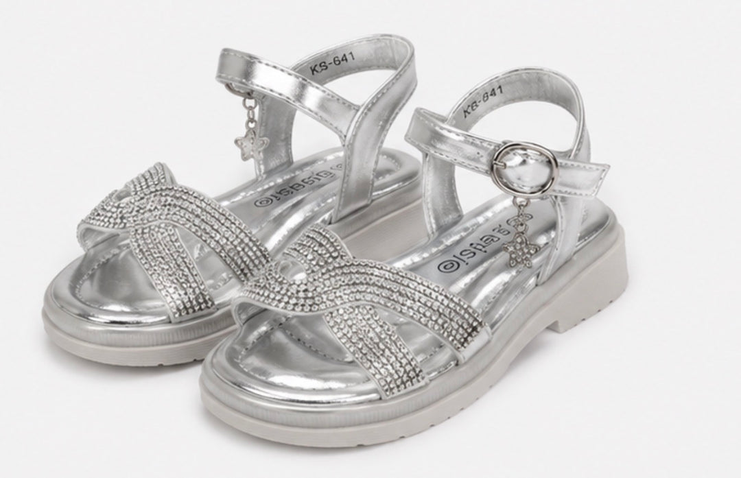 Girls silver diamante sandals with sparkling crossover straps, metallic silver finish and a dangling crystal clover charm