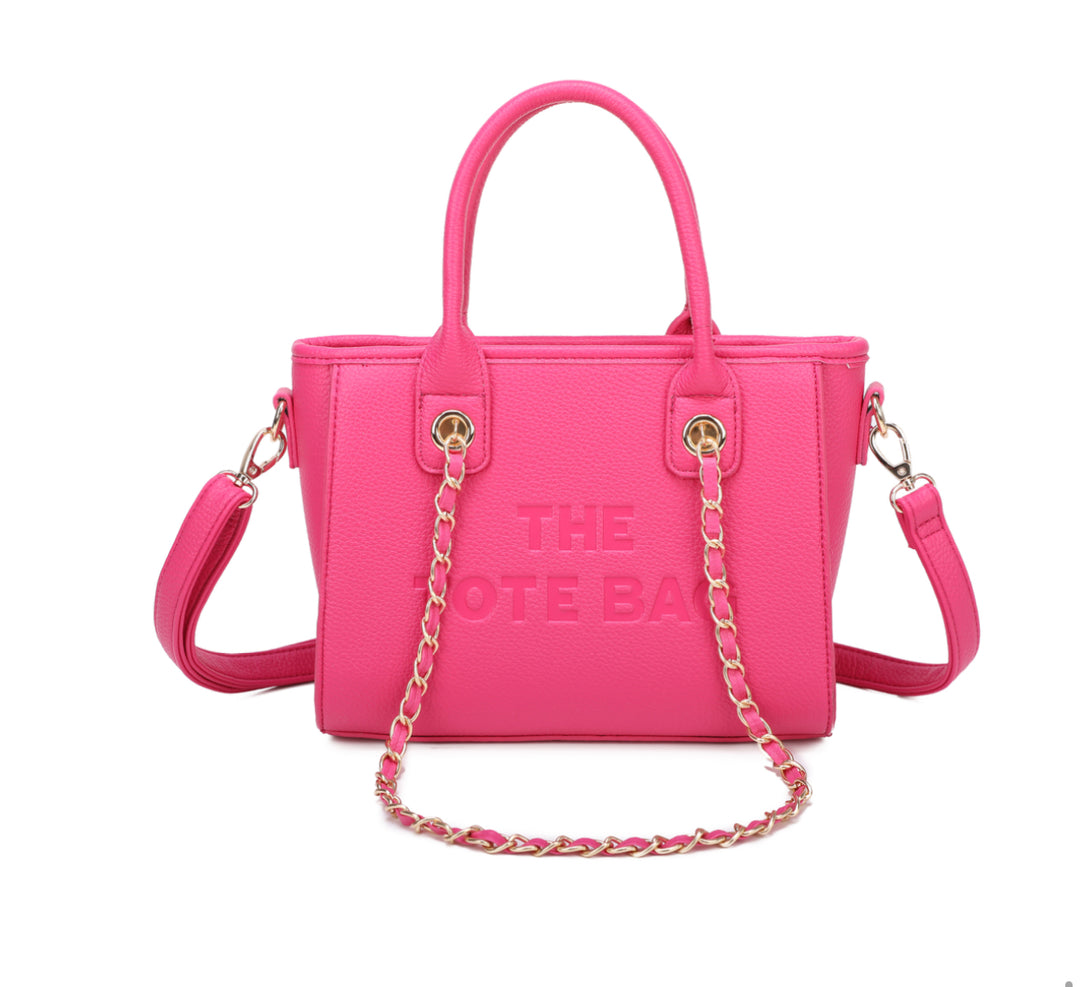 A hot pink tote bag with a chain handle, featuring a front zipper pocket and gold tone metal hardware. The &