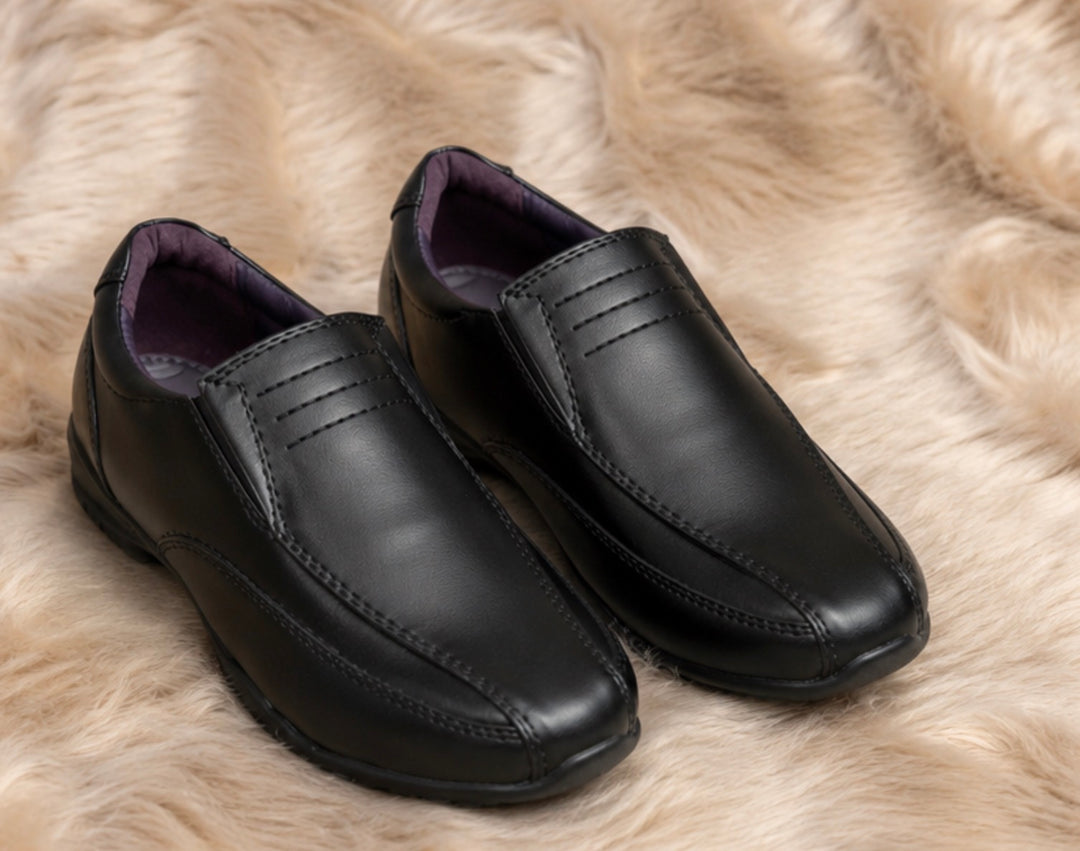Boys black smart shoes with smooth leather-look finish and comfortable low wedge sole.