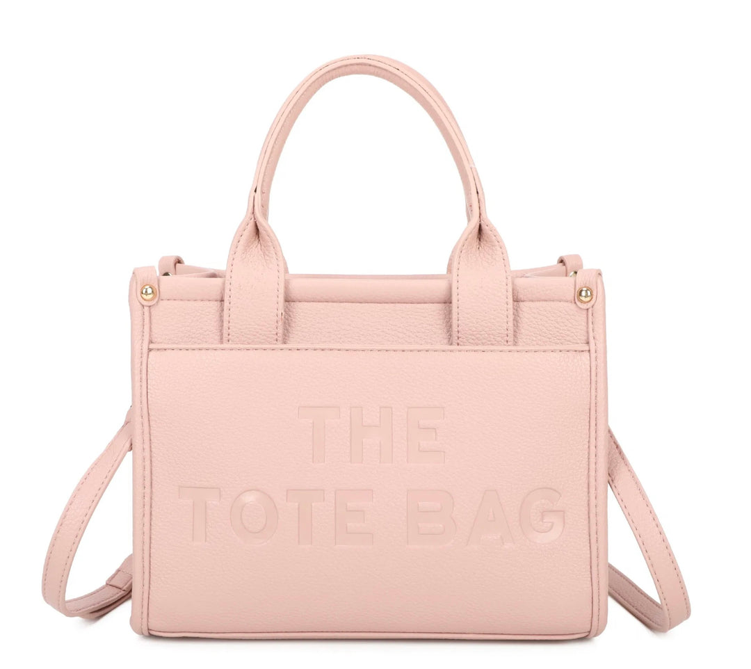 A pink tote bag with the text &