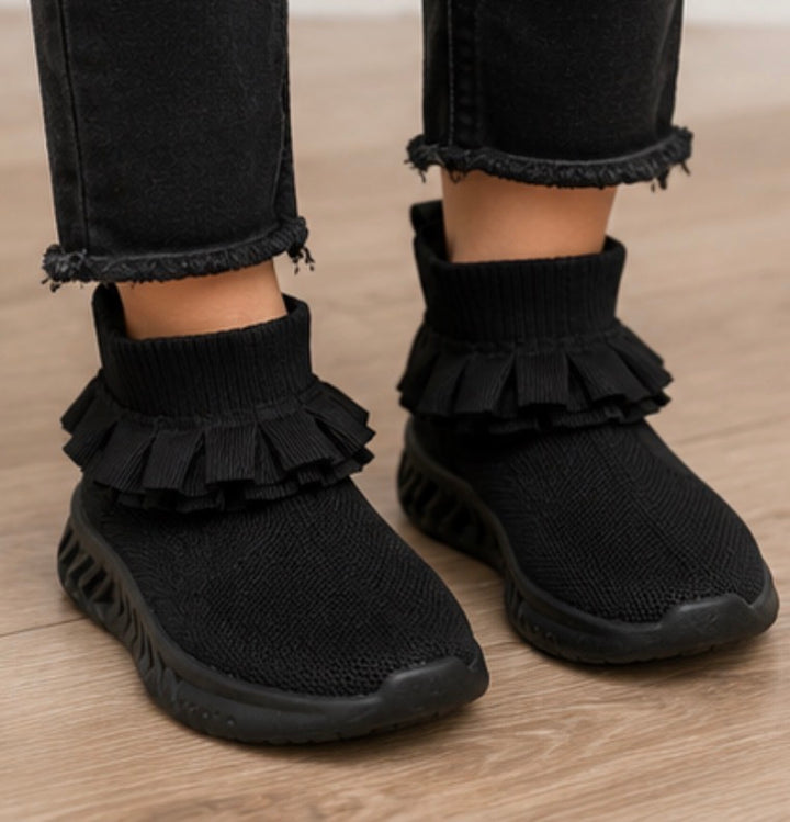 Black kids’ sock-style trainers with layered ruffle ankle detail and chunky black sole