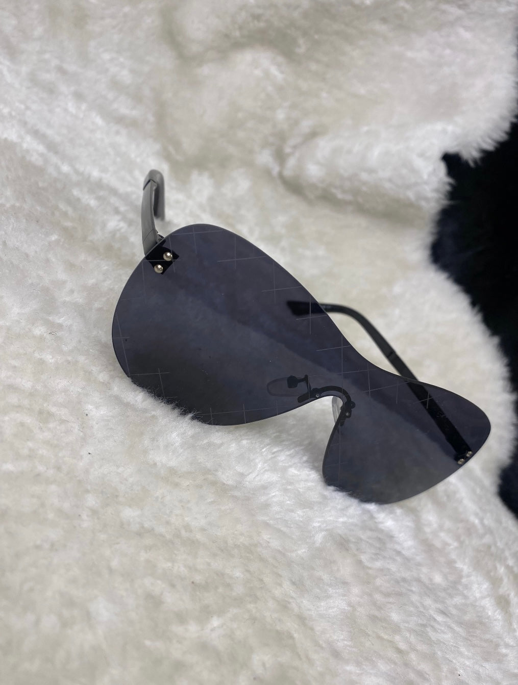 A pair of black cross design sunglasses