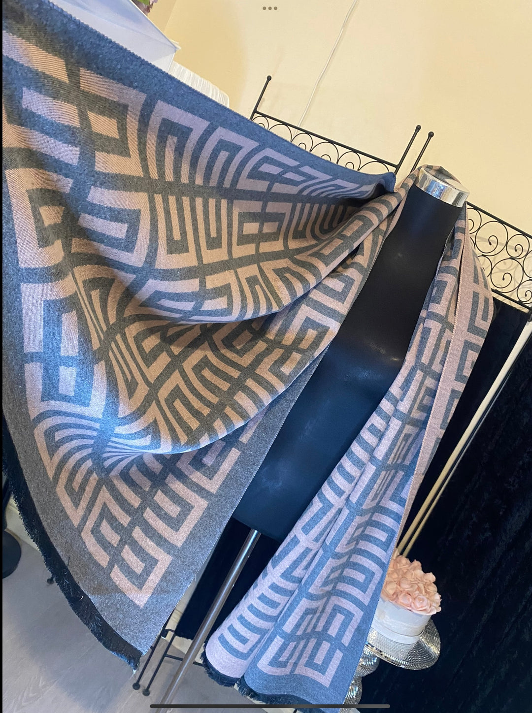 A geometric print scarf draped over a mannequin with a mix of geometric shapes in a monochrome colour palette.