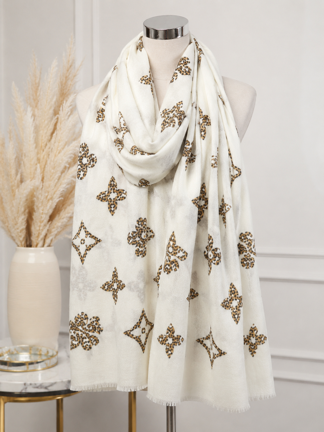 Cream statement scarf with brown and black leopard-print motifs and subtle fringed edging.