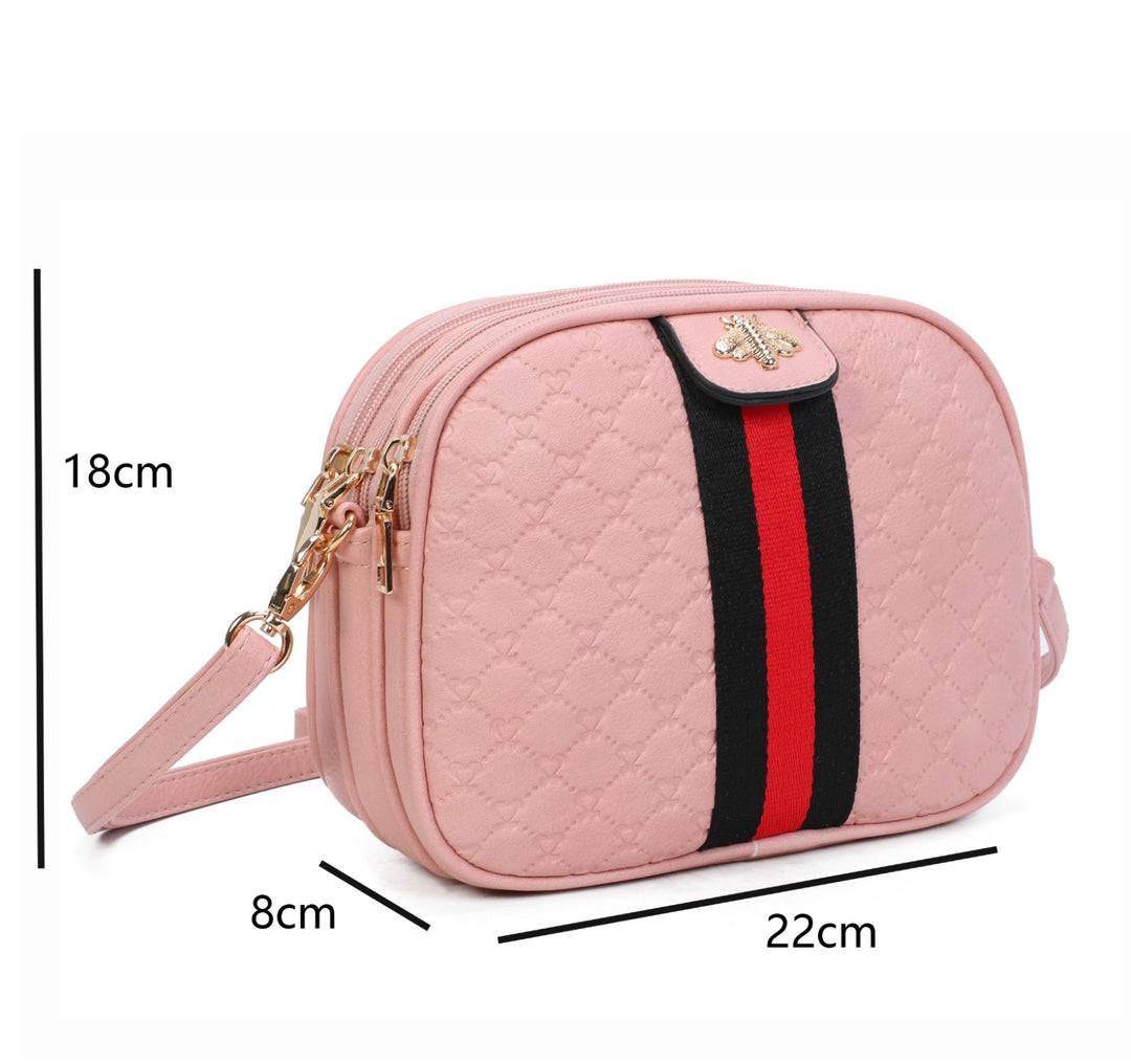 A pink quilted bee design cross body bag with a detachable and adjustable strap, featuring golden tone metal hardware. measurements displayed