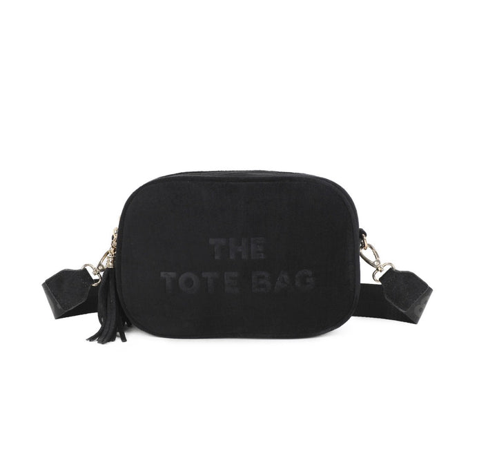 The Tote Bag black double zip crossbody bag with tassel detail and adjustable strap.