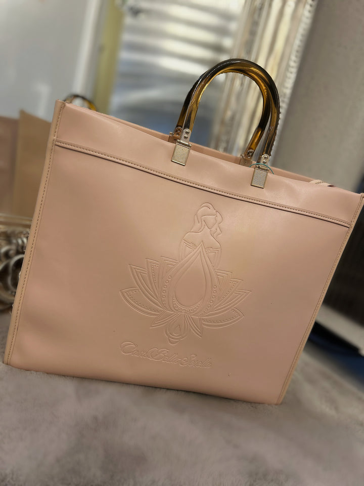 nude faux leather tote bag with the cbs logo on the front