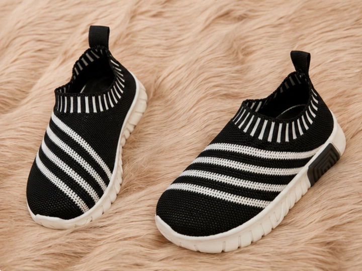 slip-on trainers in black and white design with lightweight flexible soles.