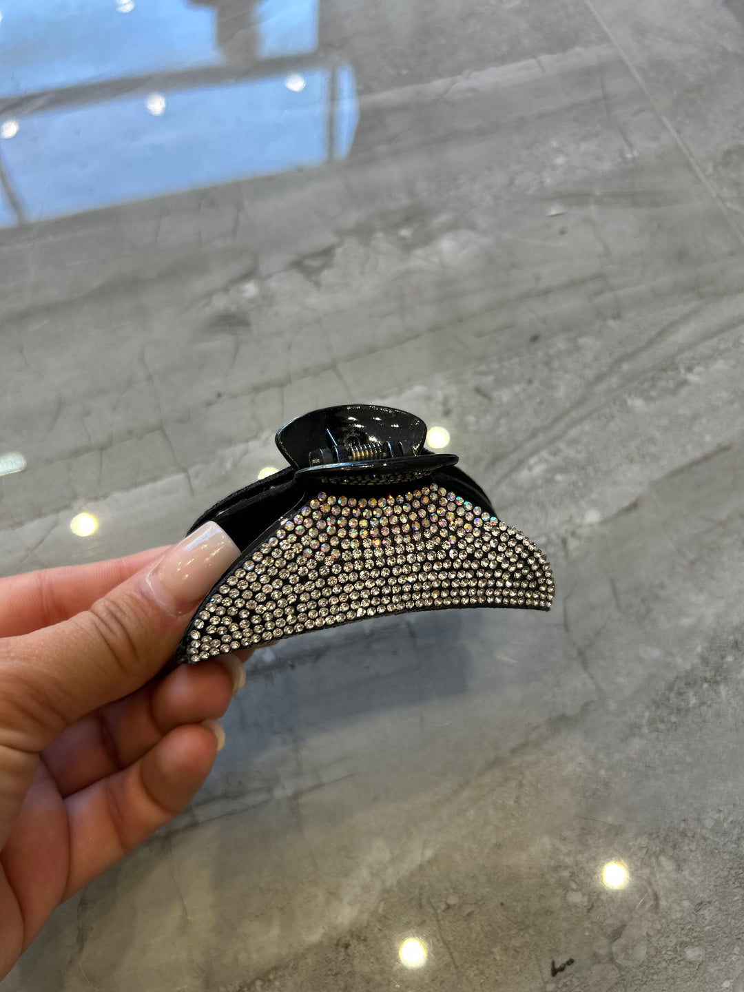 A black hair clip detailed with silver crystal rhinestones 
