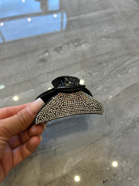 A black hair clip detailed with silver crystal rhinestones 