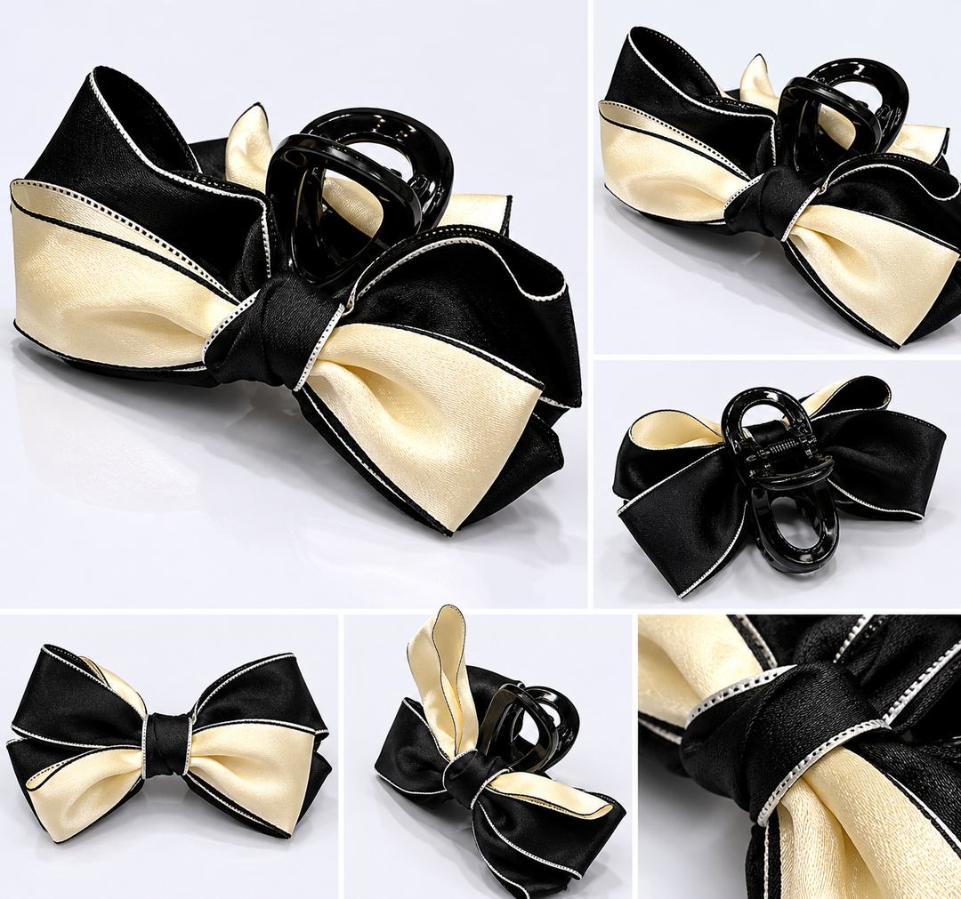 Black and cream satin bow hair clip with contrasting trim detail and glossy claw clip fastening