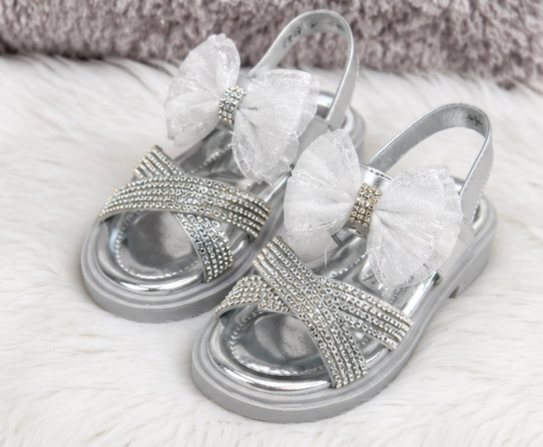 Silver girls’ sandals with sparkling diamanté crossover straps, oversized glitter mesh bow detail 