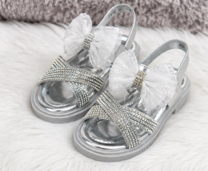 Silver girls’ sandals with sparkling diamanté crossover straps, oversized glitter mesh bow detail 