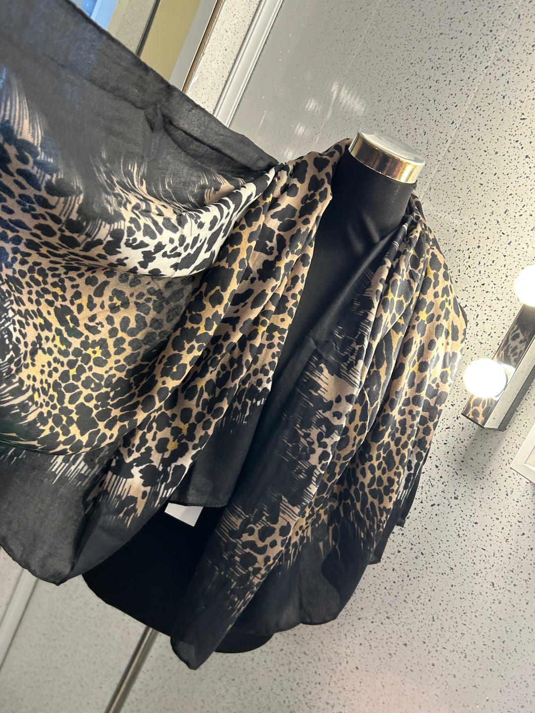 A leopard print thin scarf with a black border