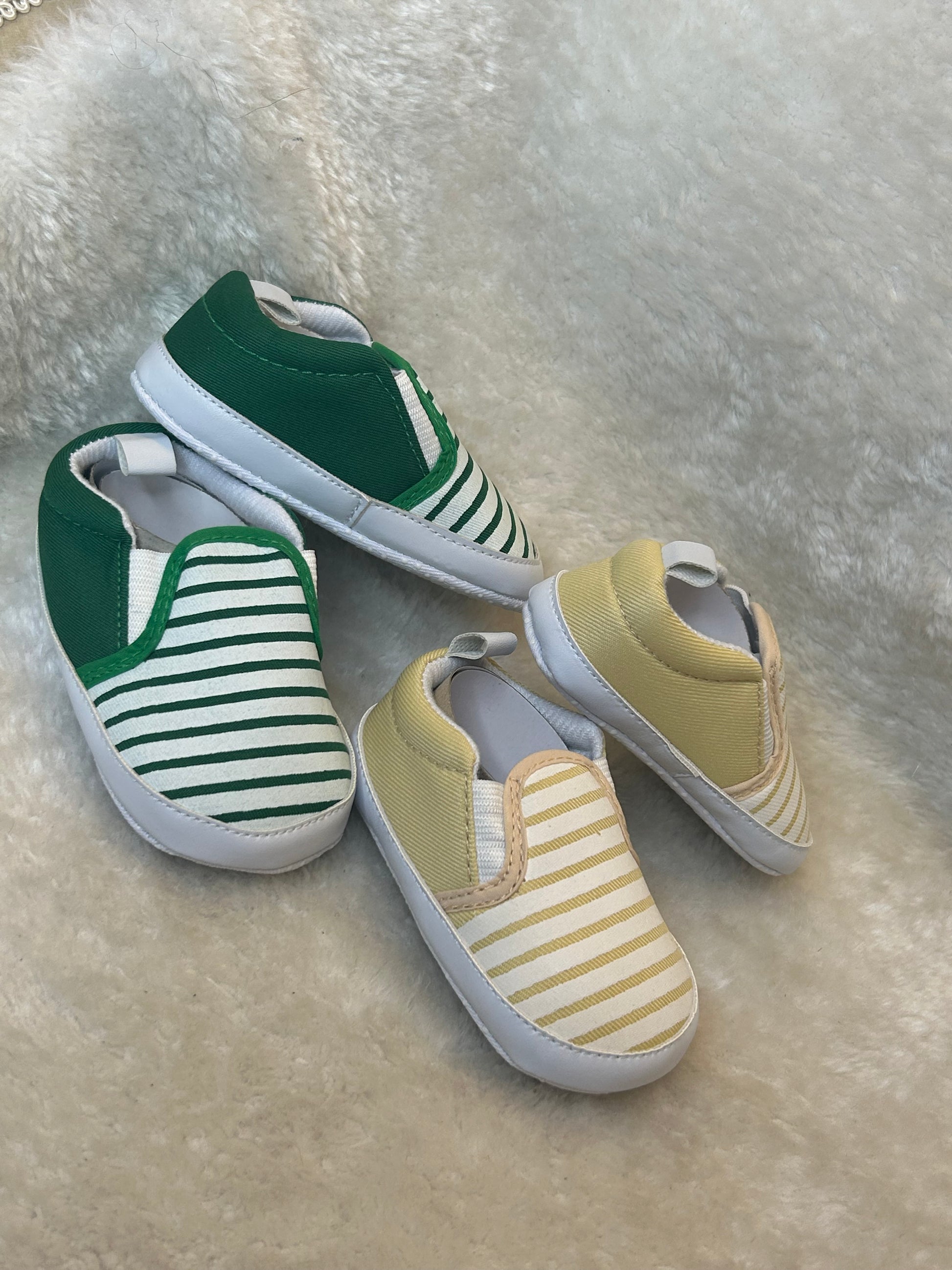 Baby slip-on shoes with striped design, soft white soles with grip dots