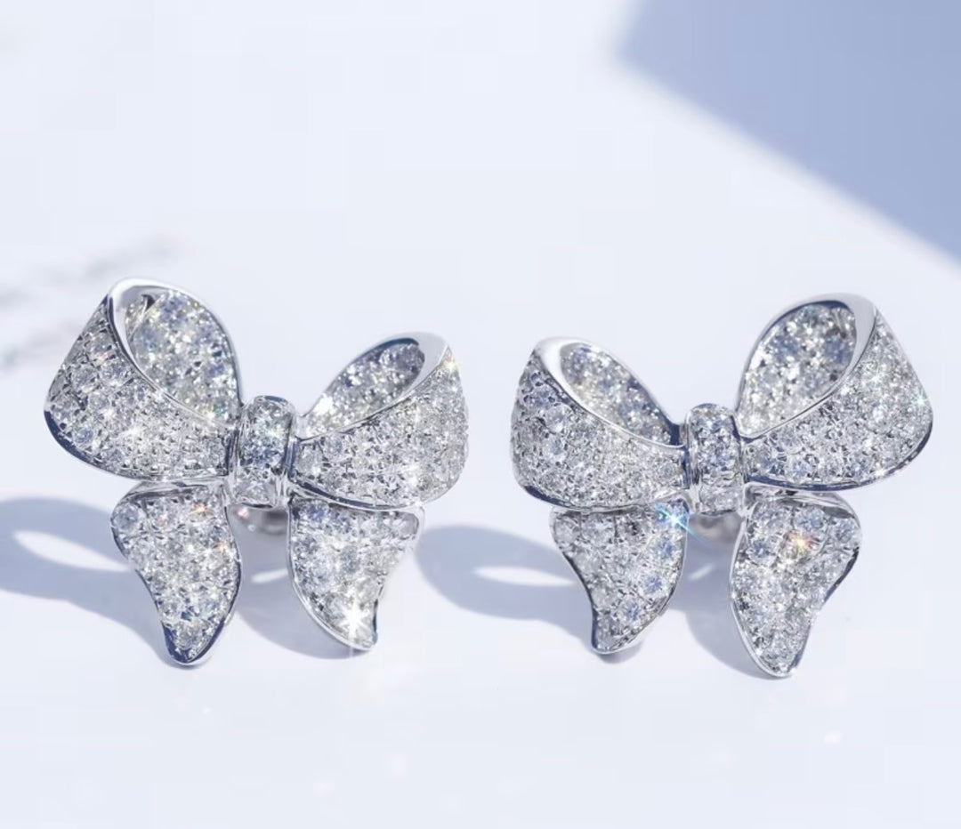 Sparkling crystal bow stud earrings silver tone