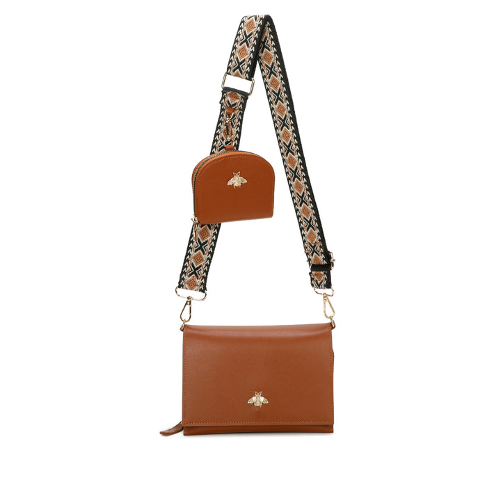 Brown faux leather crossbody bag with a patterned strap and purse on a white background