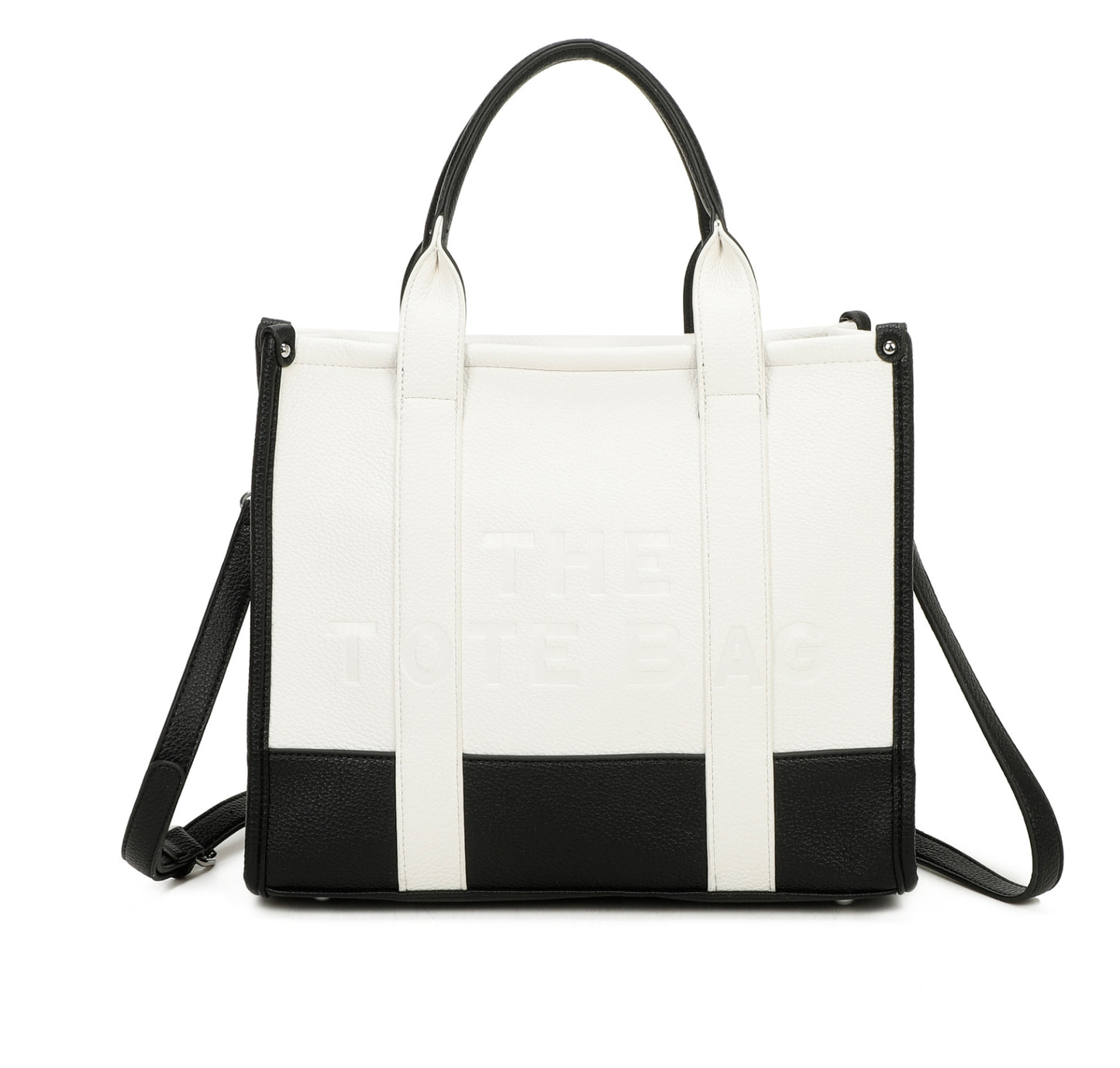 White and black handbag with 'The tote bag ‘ embossed into the front with silver hard wear 