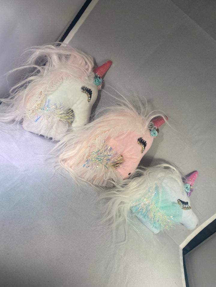 A set of three unicorn-themed key ring chains in pink, white, and blue colors, with glitter and decorative elements.