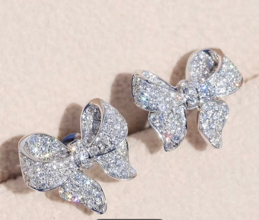 Sparkling crystal bow stud earrings silver tone