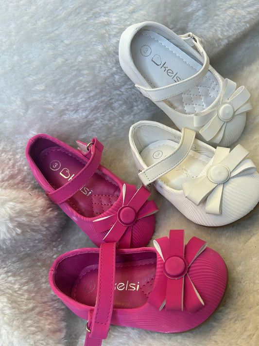 shoes in pink and white with quilted insole and large bow detail on the front