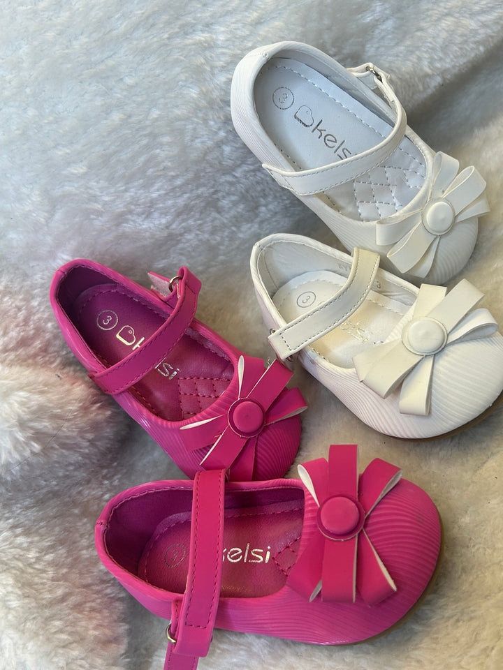 shoes in pink and white with quilted insole and large bow detail on the front