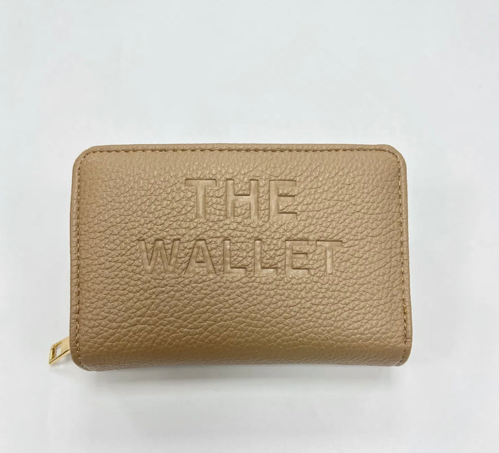 Beige purse with gold hardware and “the wallet” embossed on the front