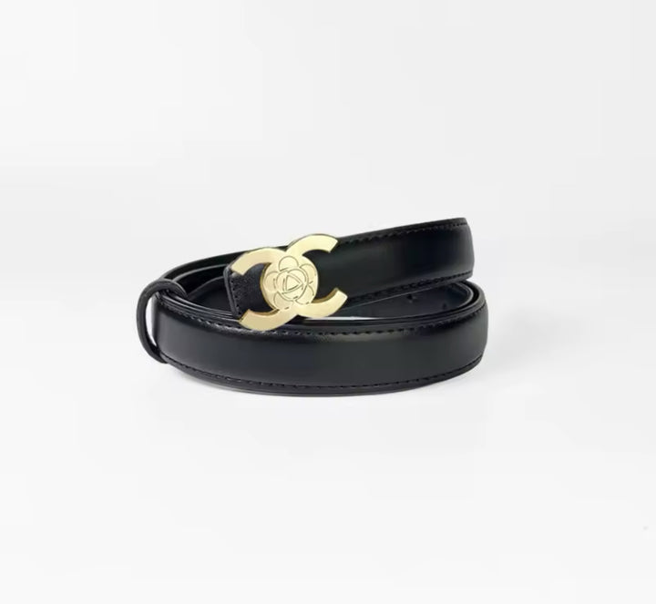 A faux leather black belt with a gold buckle,