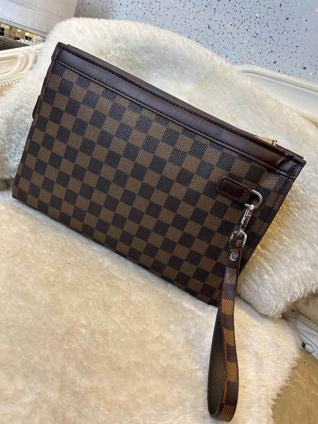 Checkered wallet clutch bag with a brown and black pattern 