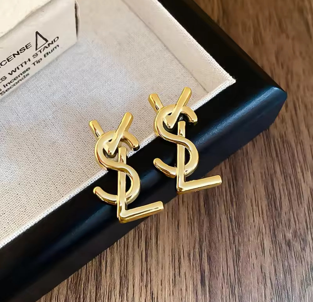 Pair of gold letter-shaped stud earrings with interlocking design 