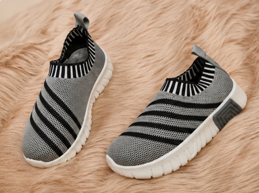 slip-on trainers in grey and black design with lightweight flexible soles.