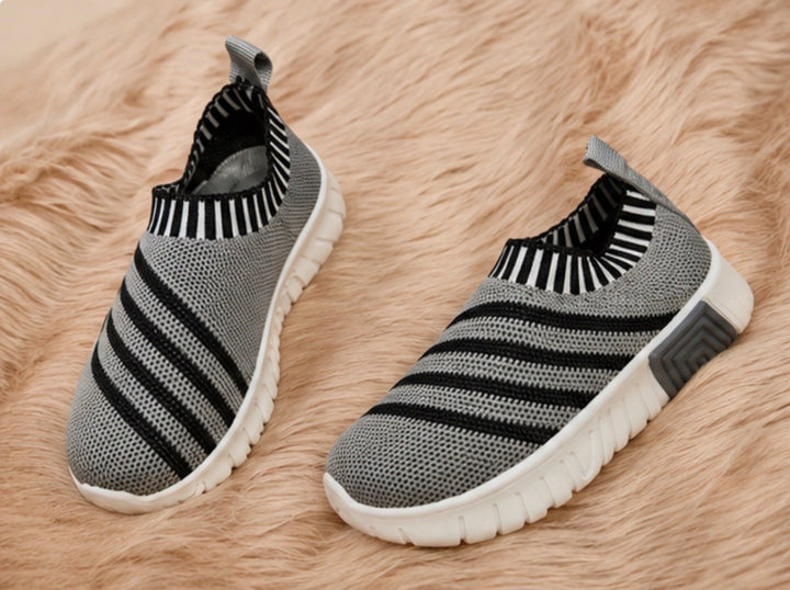 slip-on trainers in grey and black design with lightweight flexible soles.
