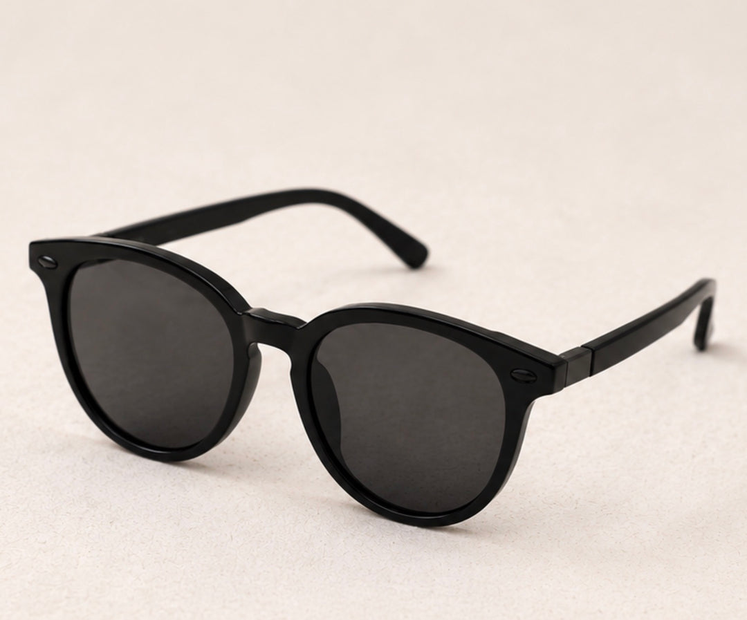 Black round frame sunglasses with dark tinted lenses and black hardware detail