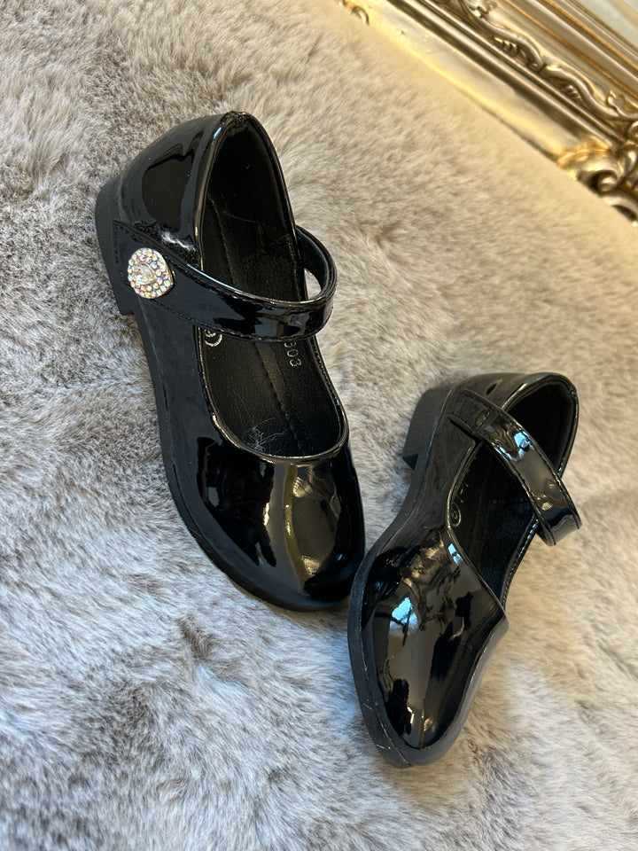 A pair of black, patent leather little girl&