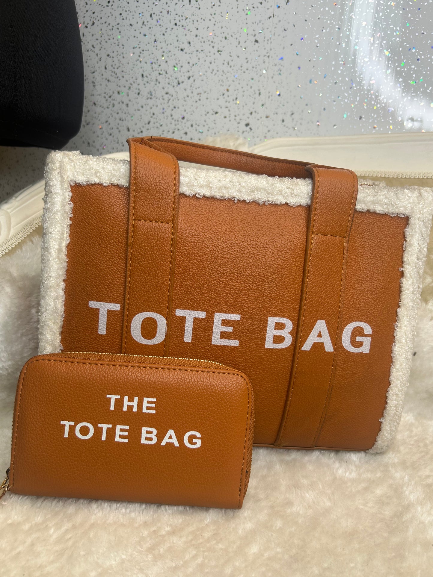 Brown tote bag with 'TOTE BAG' text and a matching purse 