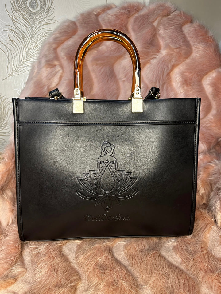 black faux leather tote bag with the cbs logo on the front