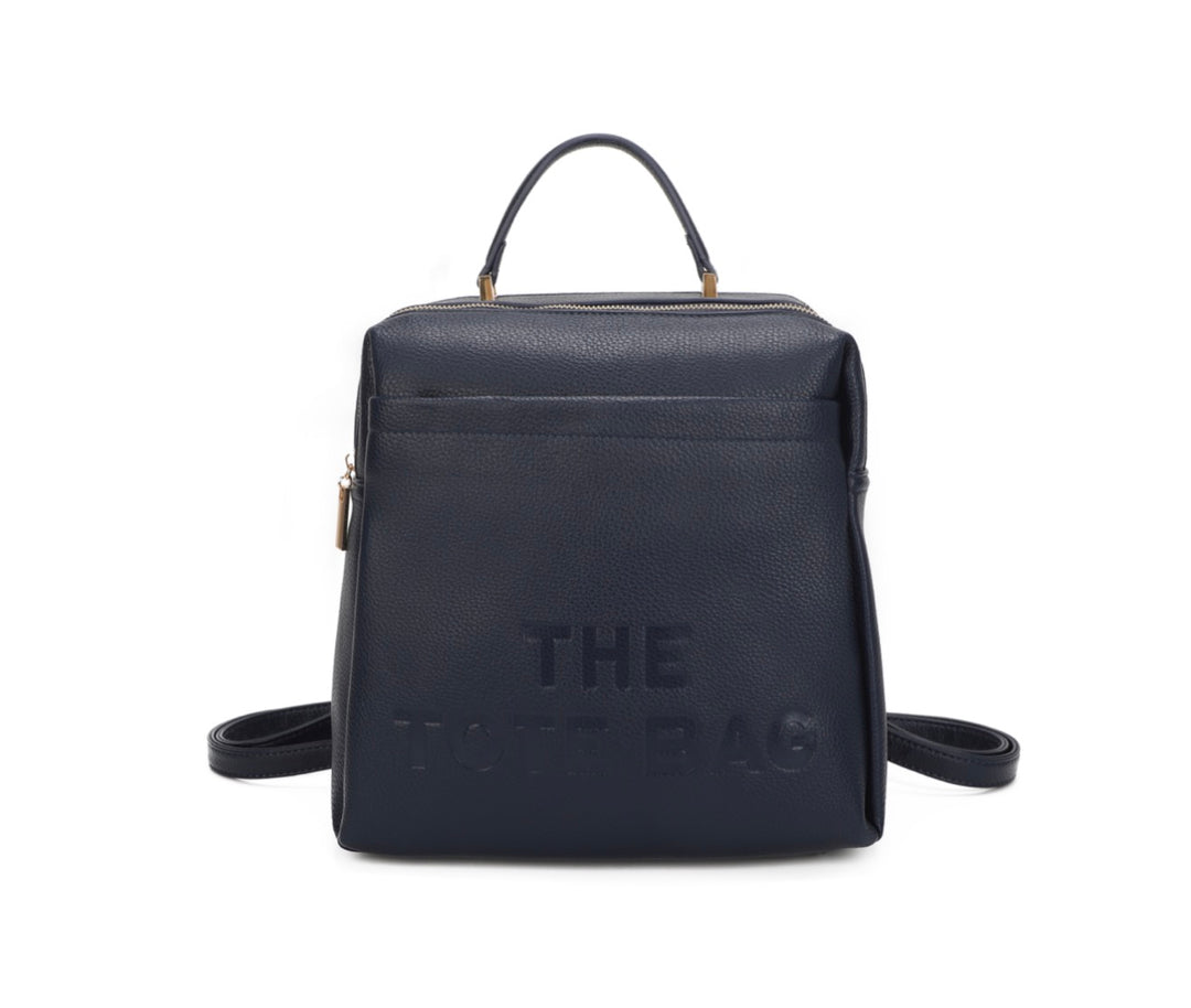 Navy rucksack with embossed “ the tote bag” writing on the front 