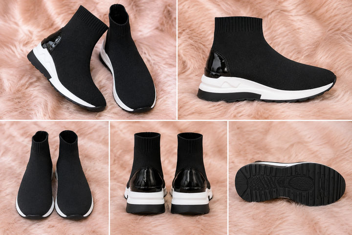 A pair of black and white slip-on trainers with a wedge sole.