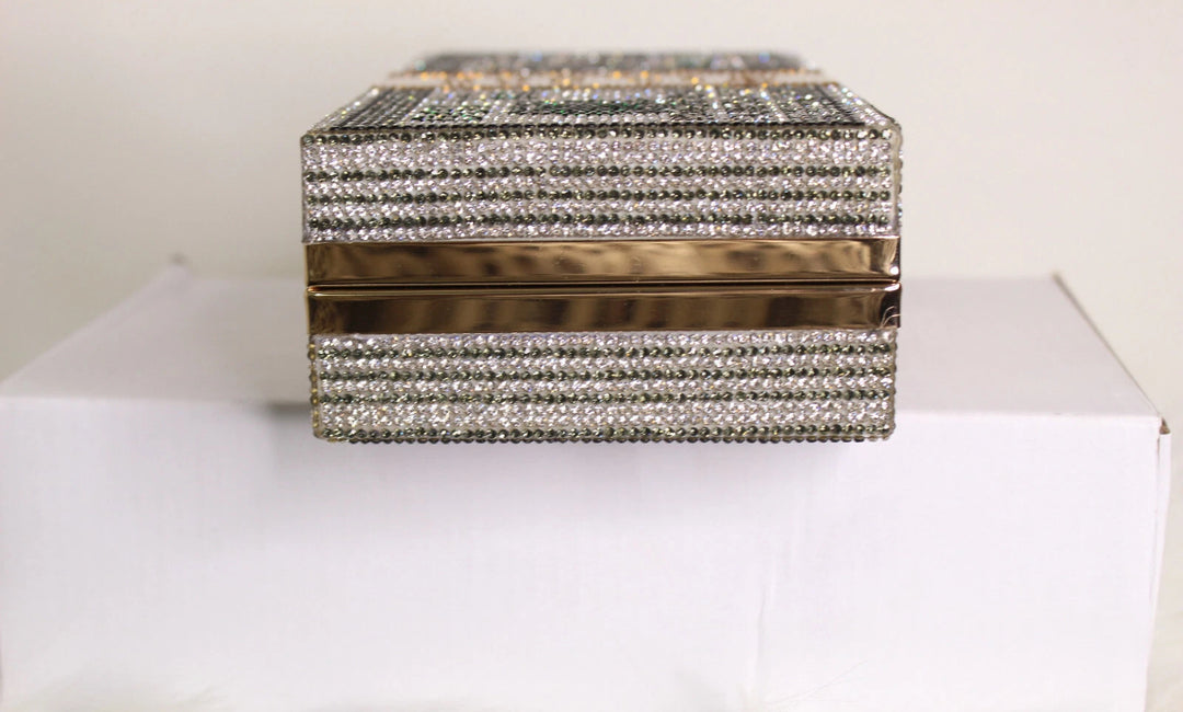 Decorative box with crystal embellishments on a white surface